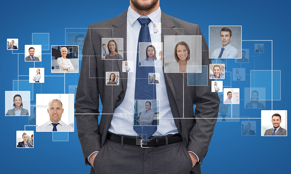 man in suit surrouned by images of staff